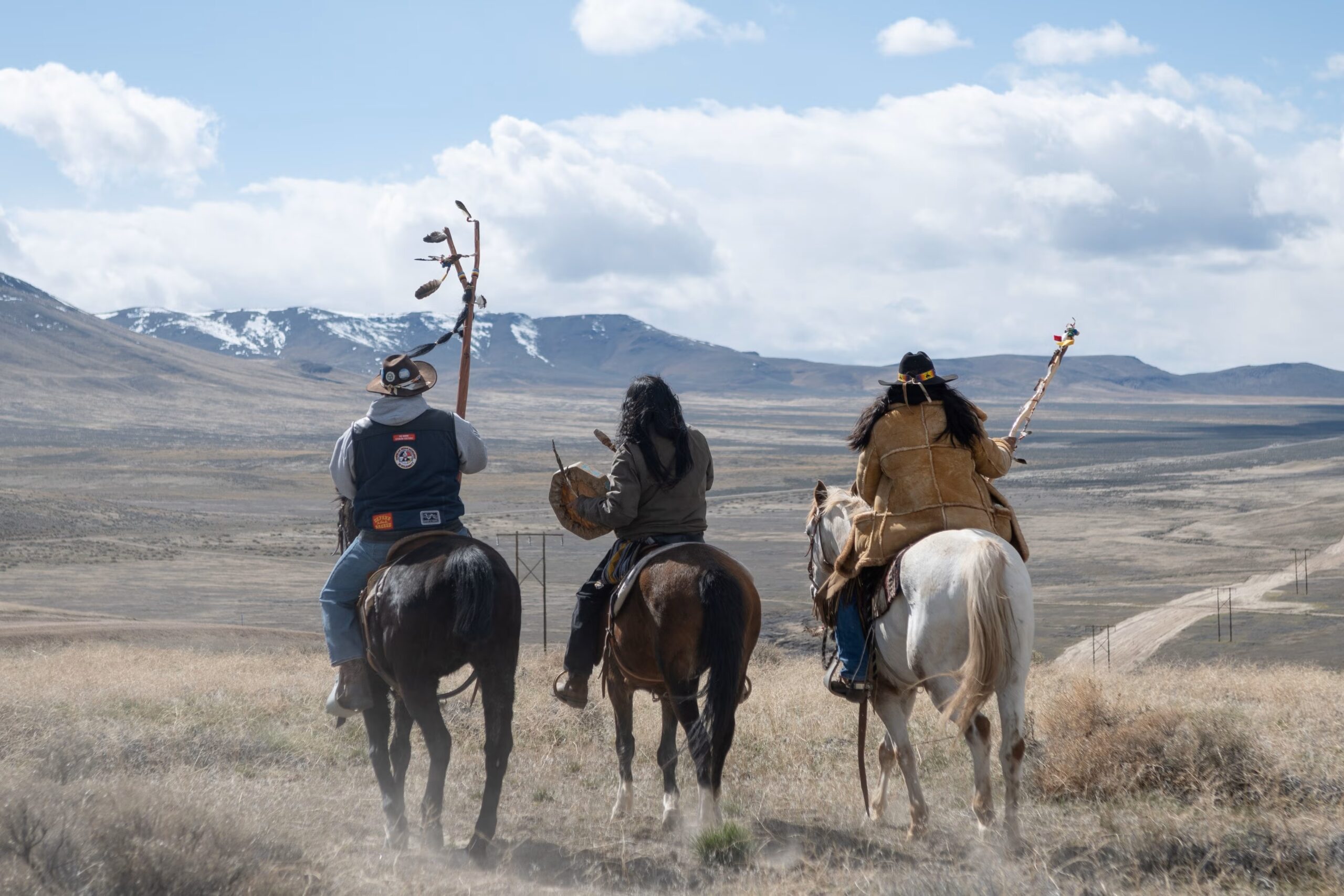 Numu/Nuwu and Newe prayer riders overlooking the ongoing construction that is destroying the sacred land of Peehee Mu’huh. Nevada, March 26, 2024. © 2024 David Calvert